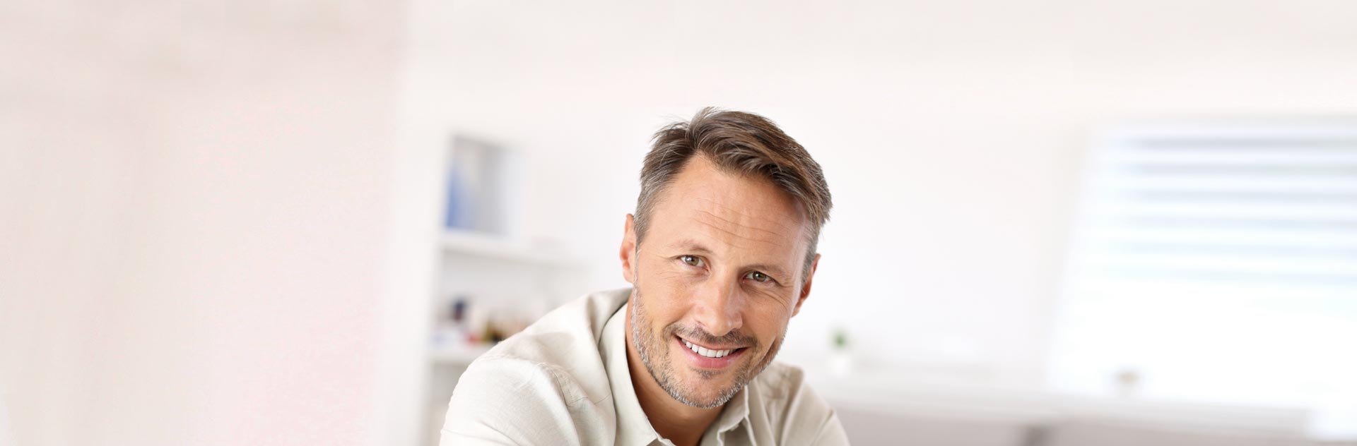 Hombre sonriendo tras optar por las Pelucas Estéticas de Capilárea